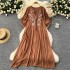 Slightly chubby and slimming dress for women in summer, with a lazy and relaxed style. Loose, flesh blocking, lace up, round neck, lantern sleeves, embroidered over the knee long skirt