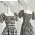 Yang Xiaojuan's French retro black and white checkered waist cinched dress exudes a feminine charm, revealing a slimming effect with bubble sleeves and a long skirt for tea breaks