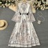 Spring new retro printed round neck flared sleeve dress for women's singles with large buttons and irregular pleated long skirt