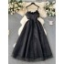 French retro Hepburn style black dress for women with a sense of luxury, featuring a cinched waist, feather patchwork, mesh, fluffy suspender, and long skirt