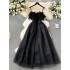 French retro Hepburn style black dress for women with a sense of luxury, featuring a cinched waist, feather patchwork, mesh, fluffy suspender, and long skirt