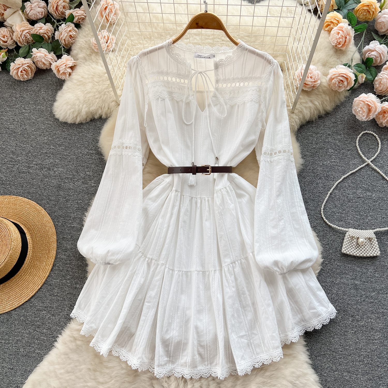 Spring lace hollow waist doll princess dress, women's long sleeved white dress, women's niche vacation style fairy dress