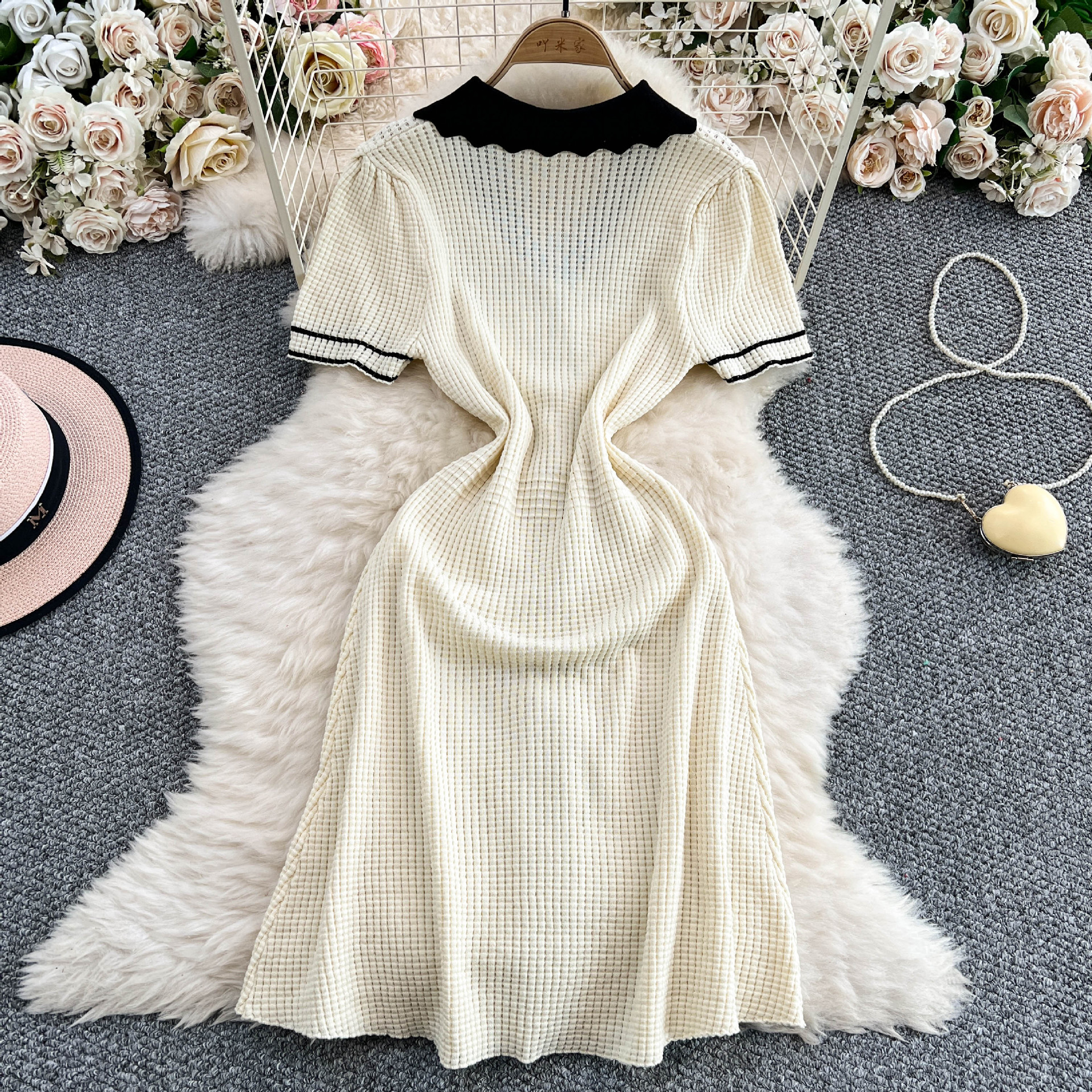 Temperament contrasting doll neck short sleeved knitted dress for women with a niche design sense, single breasted slim fit and slimming mid length skirt Temperament contrasting doll neck short sleeved knitted dress for women with a niche design sense, single breasted slim fit and slimming mid length skirt