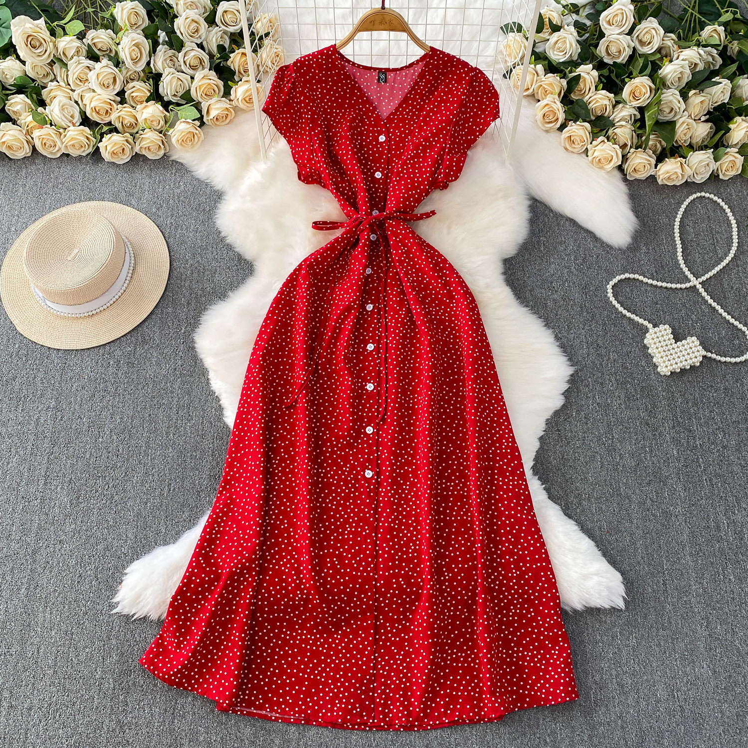 French red polka dot V-neck short sleeved dress for women in summer, with a single breasted buckle and tied waist for slimming effect. A-line medium length skirt