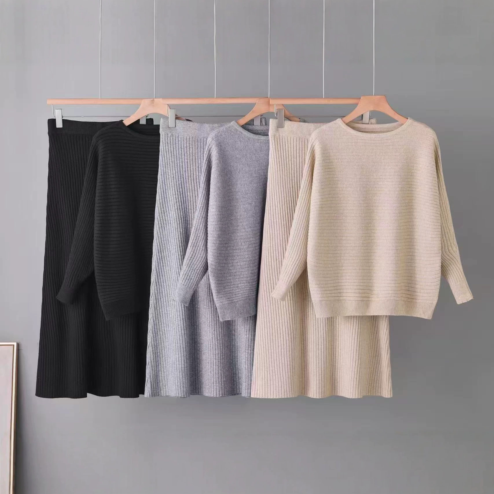 Round neck pit stripe knitted suit for women in spring and autumn, loose long sleeved top, high waisted half body long skirt, gentle solid color two-piece set